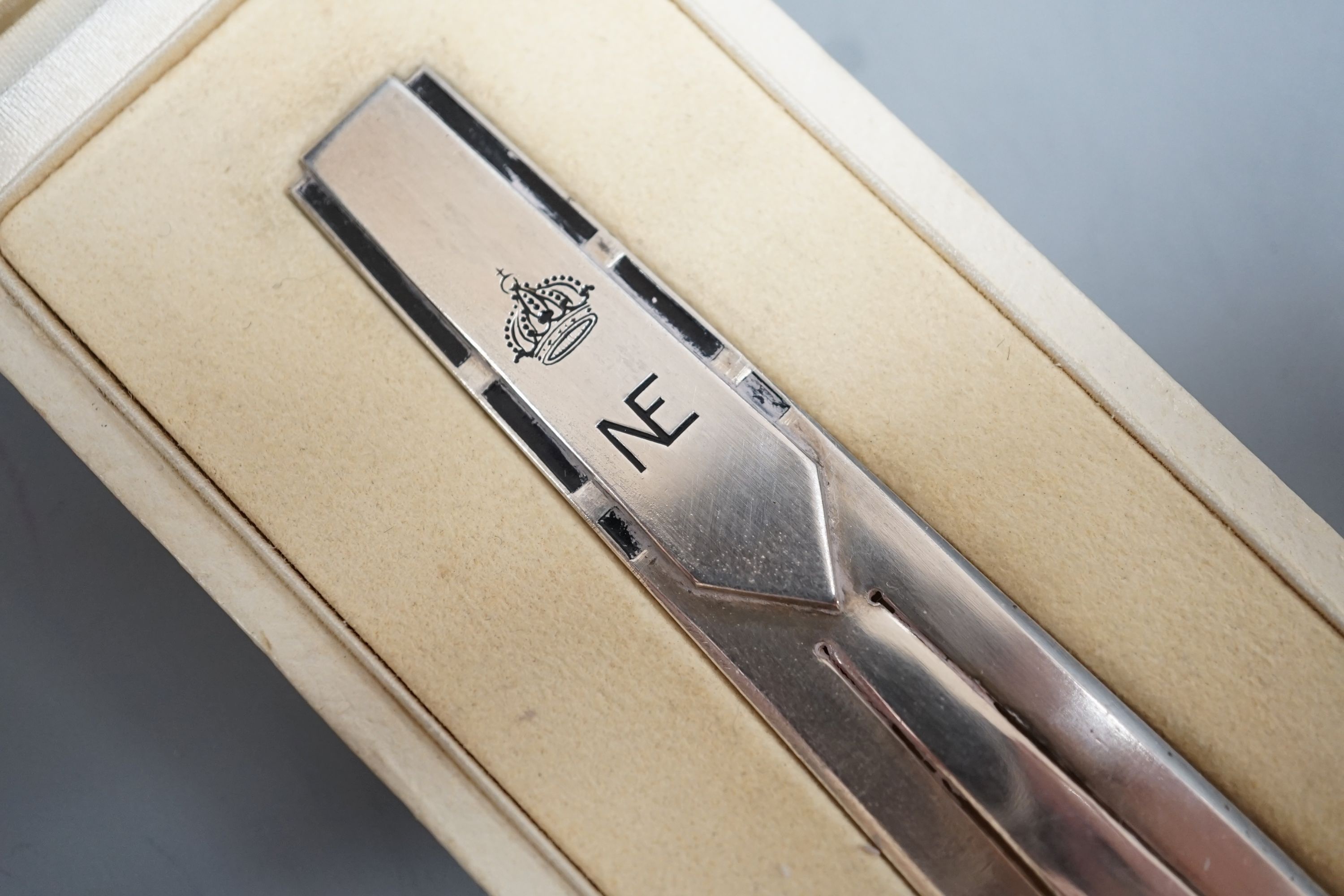 A white metal and black enamel bookmark, with NE monogram below a coronet, 12.1cm, in fitted Cartier box.